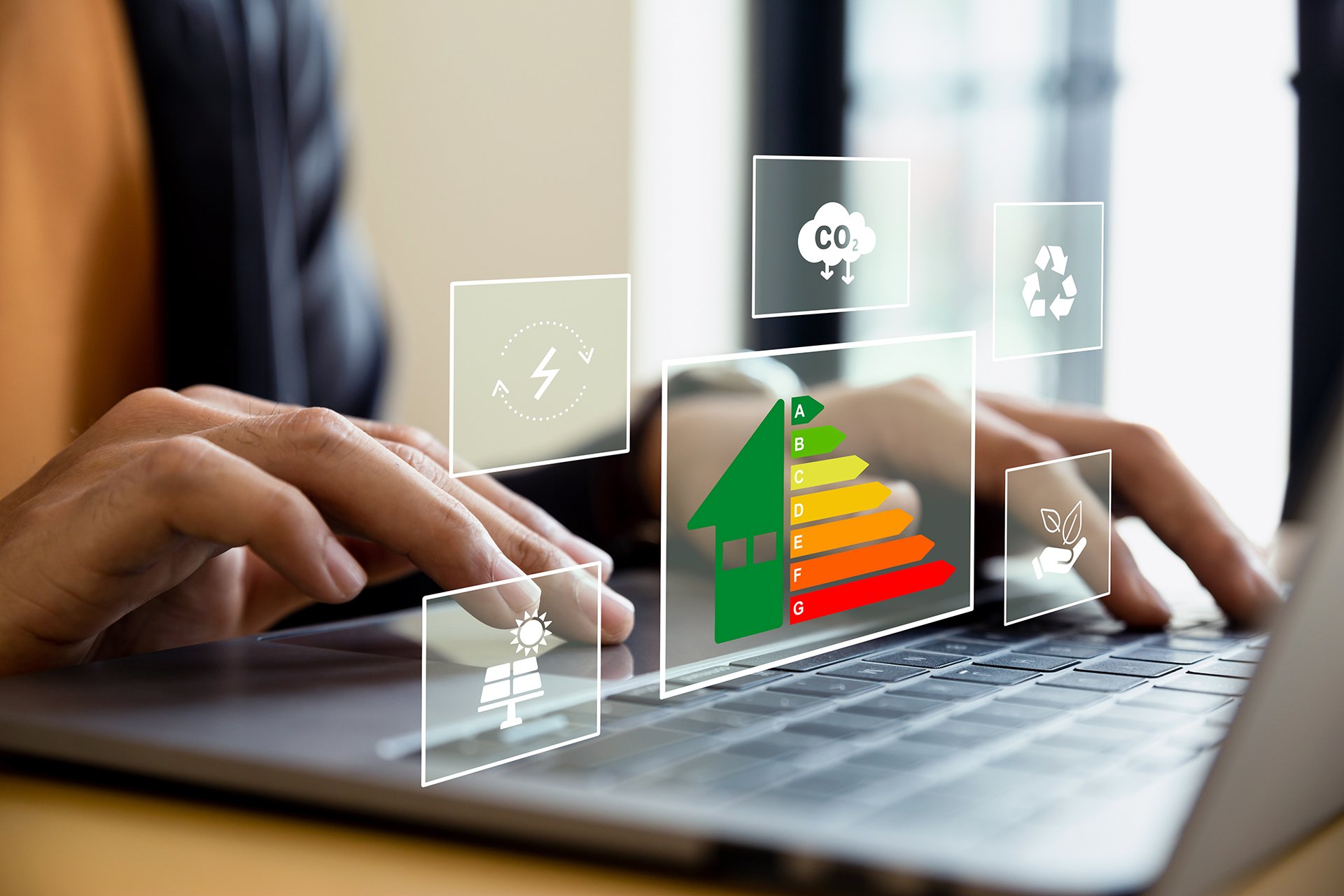 Home improvement concept, Hand of businessman using laptop with energy efficiency rating, ecological and bioenergetic house, efficiency scale. Hand of businessman using laptop with energy efficiency rating.